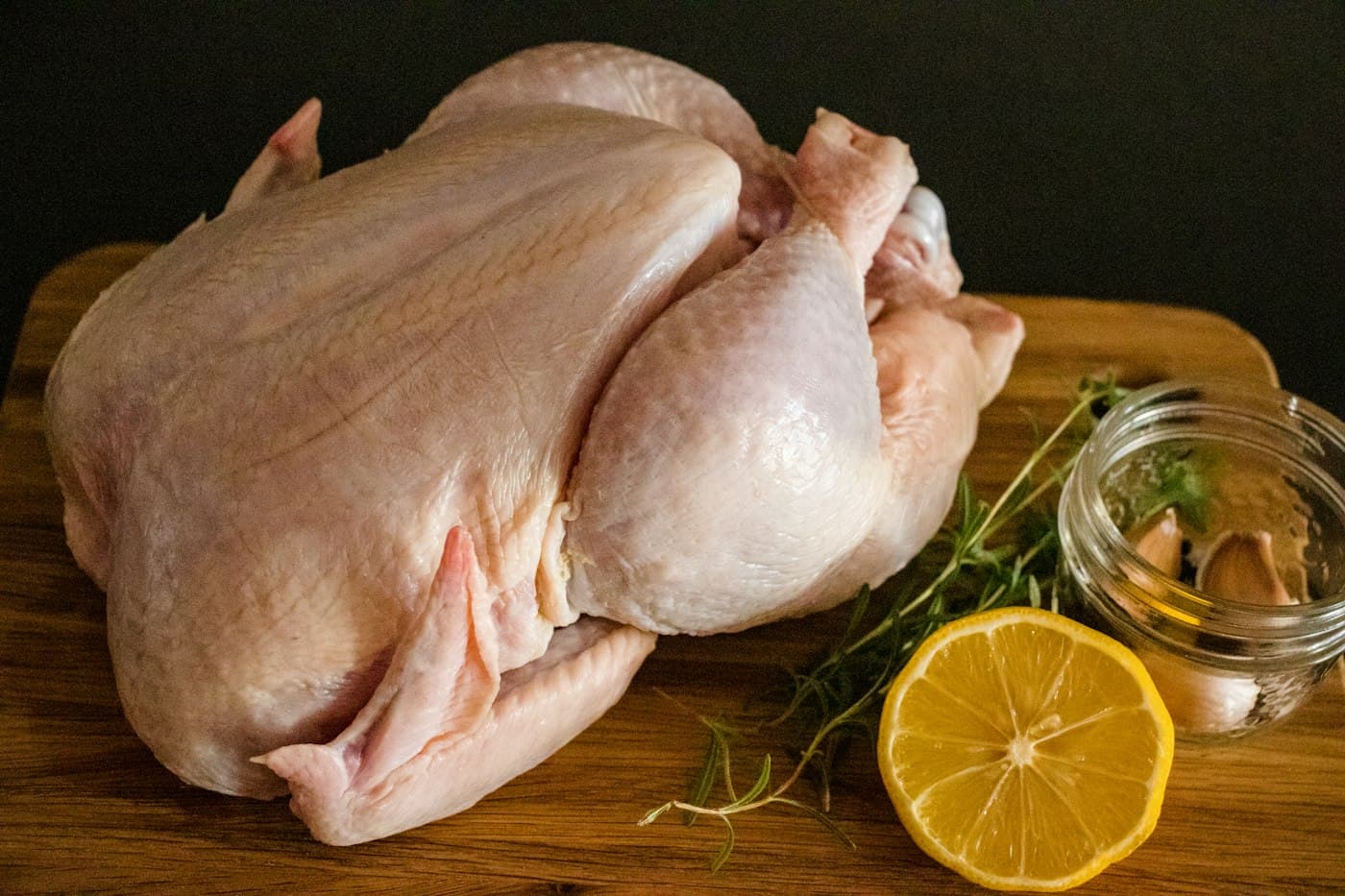 A whole chicken on a wooden board